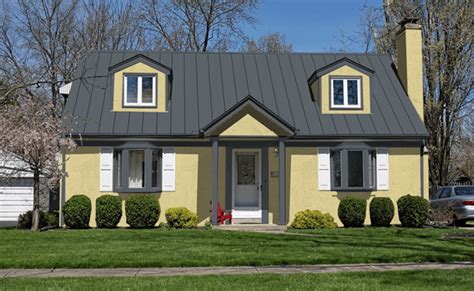 yellow houses with metal roofs|yellow house with charcoal roof.